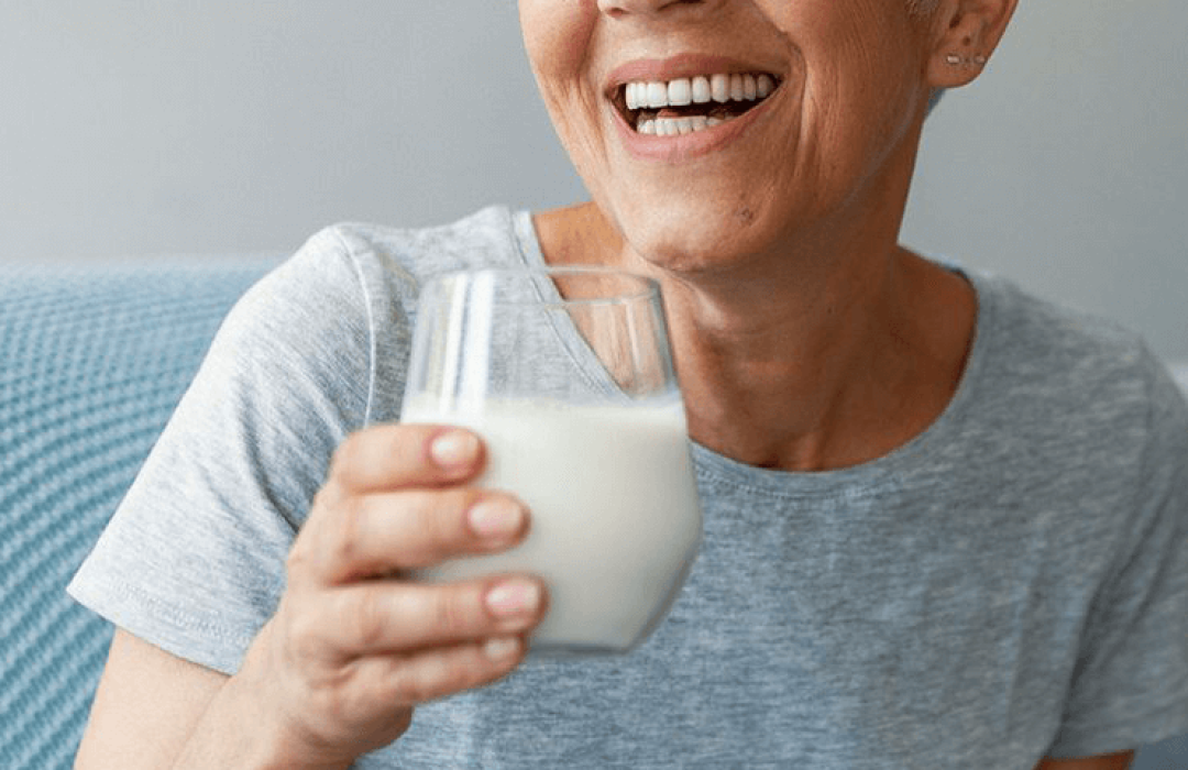 Taste Woman holding a glass of milk