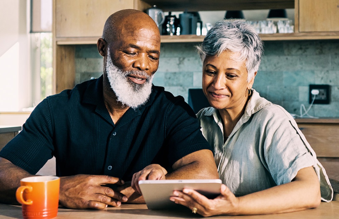 Financial Planning Senior couple reading a tablet