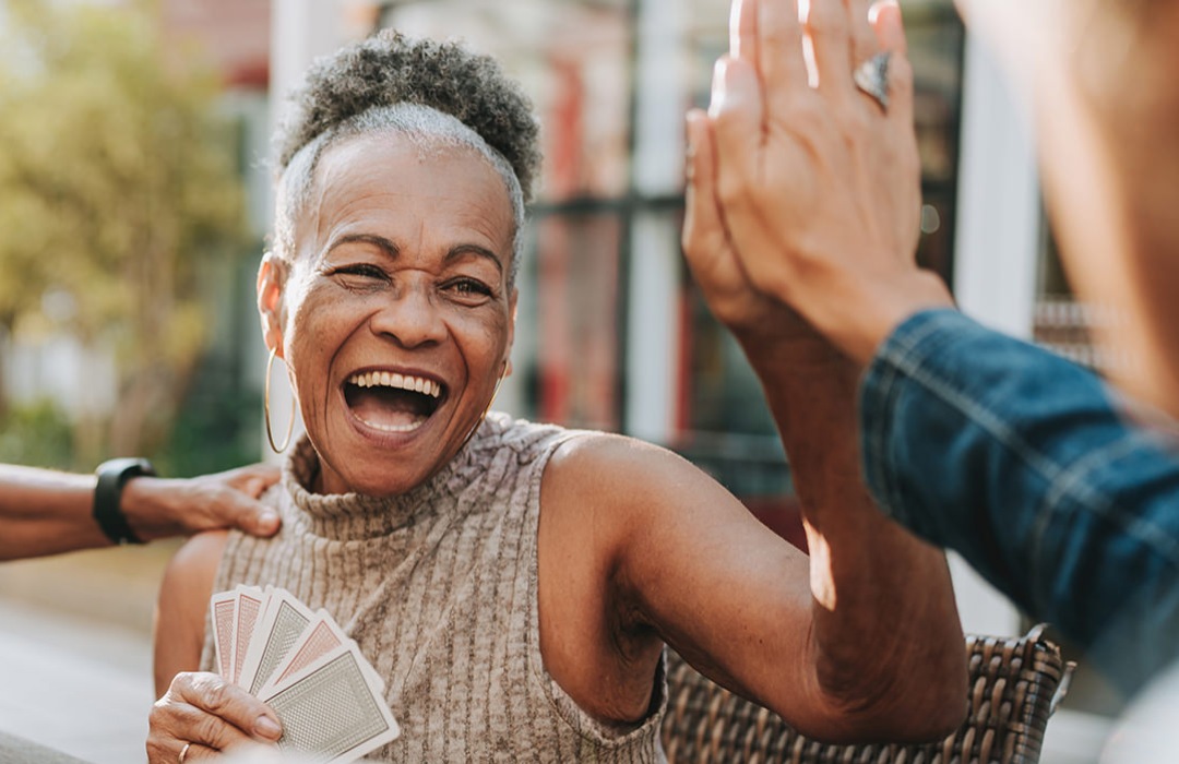 General Health & Well-Being Senior woman high fiving her friend