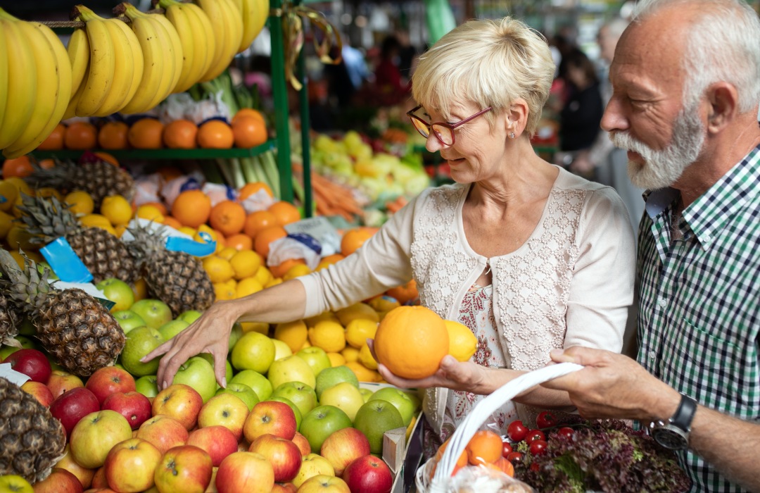 Improve Digestion Couple picking fruit at farmers market