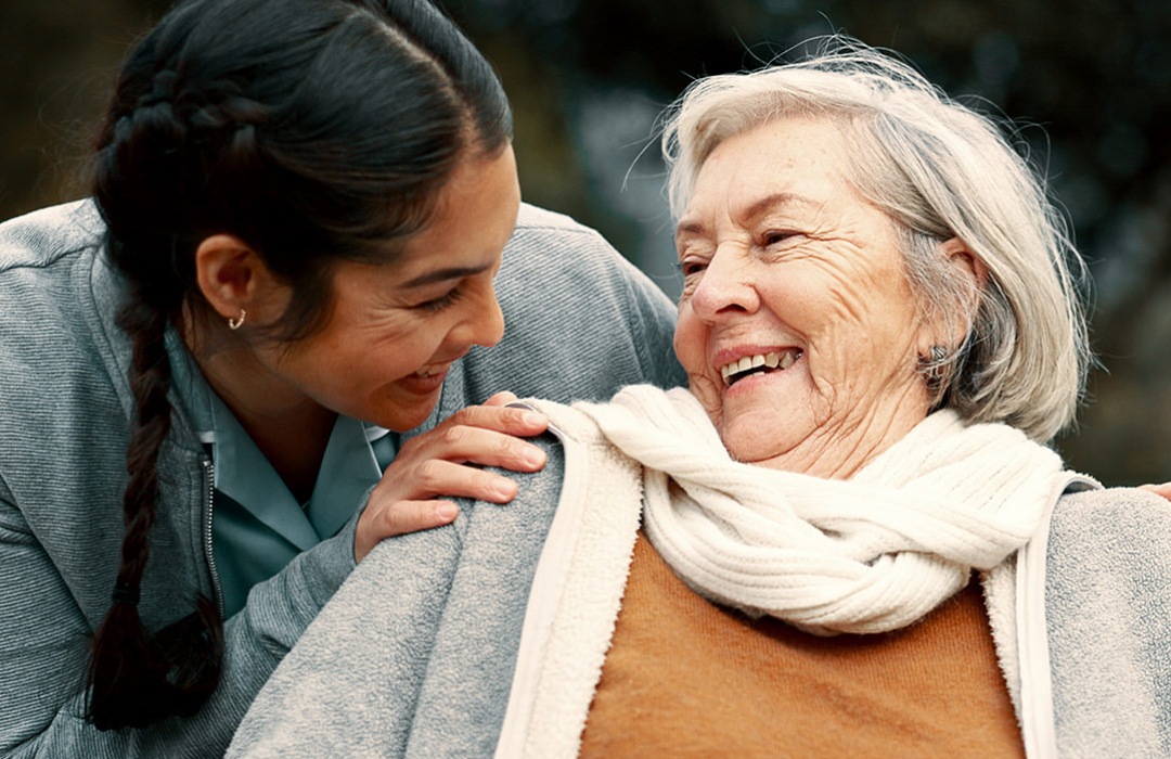 Mental & Emotional Well-Being Older woman smiling at caregiver