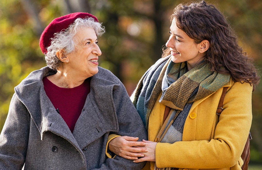 Safety Young woman helping her mother walking