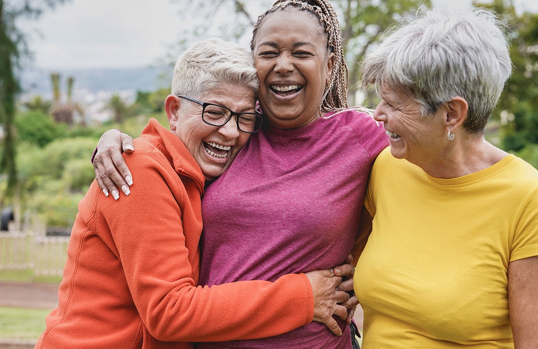 Laughter Three women hugging and laughing