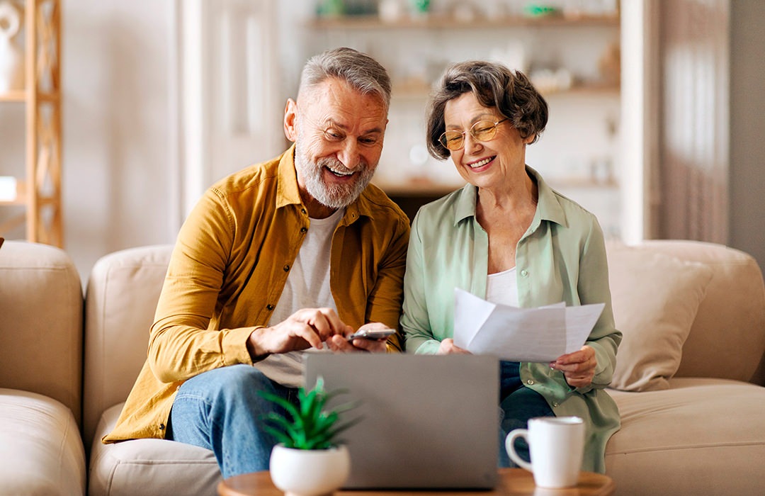 Lifestyle couple sitting on their couch drinking coffee